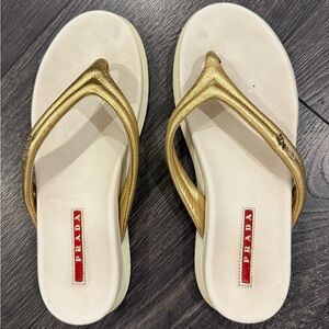 Prada flip flop sandals with gold straps